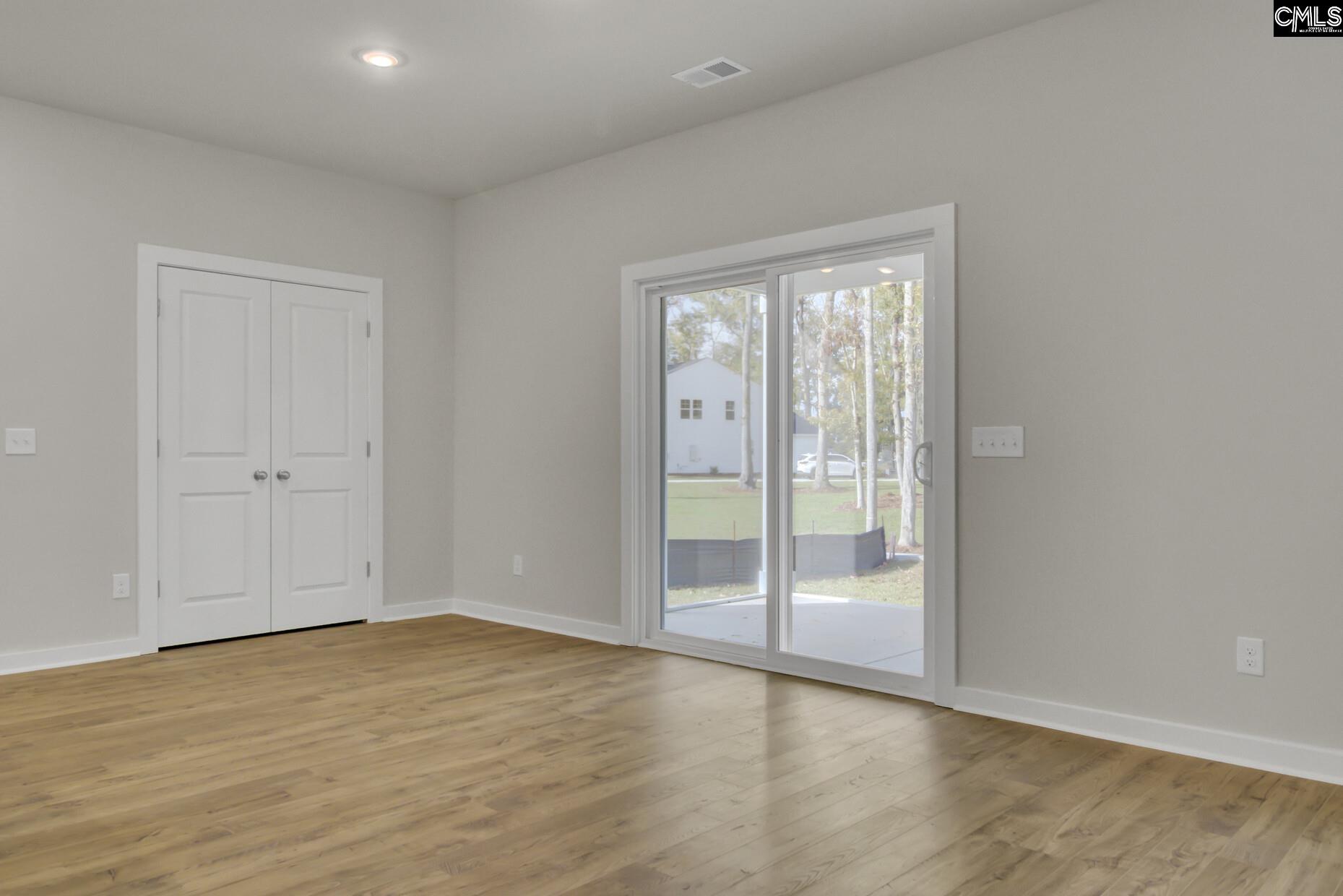 320 Brass Billion Path Lexington, SC 29073 - Photo 10 of 39 a view of an empty room with wooden floor and a window