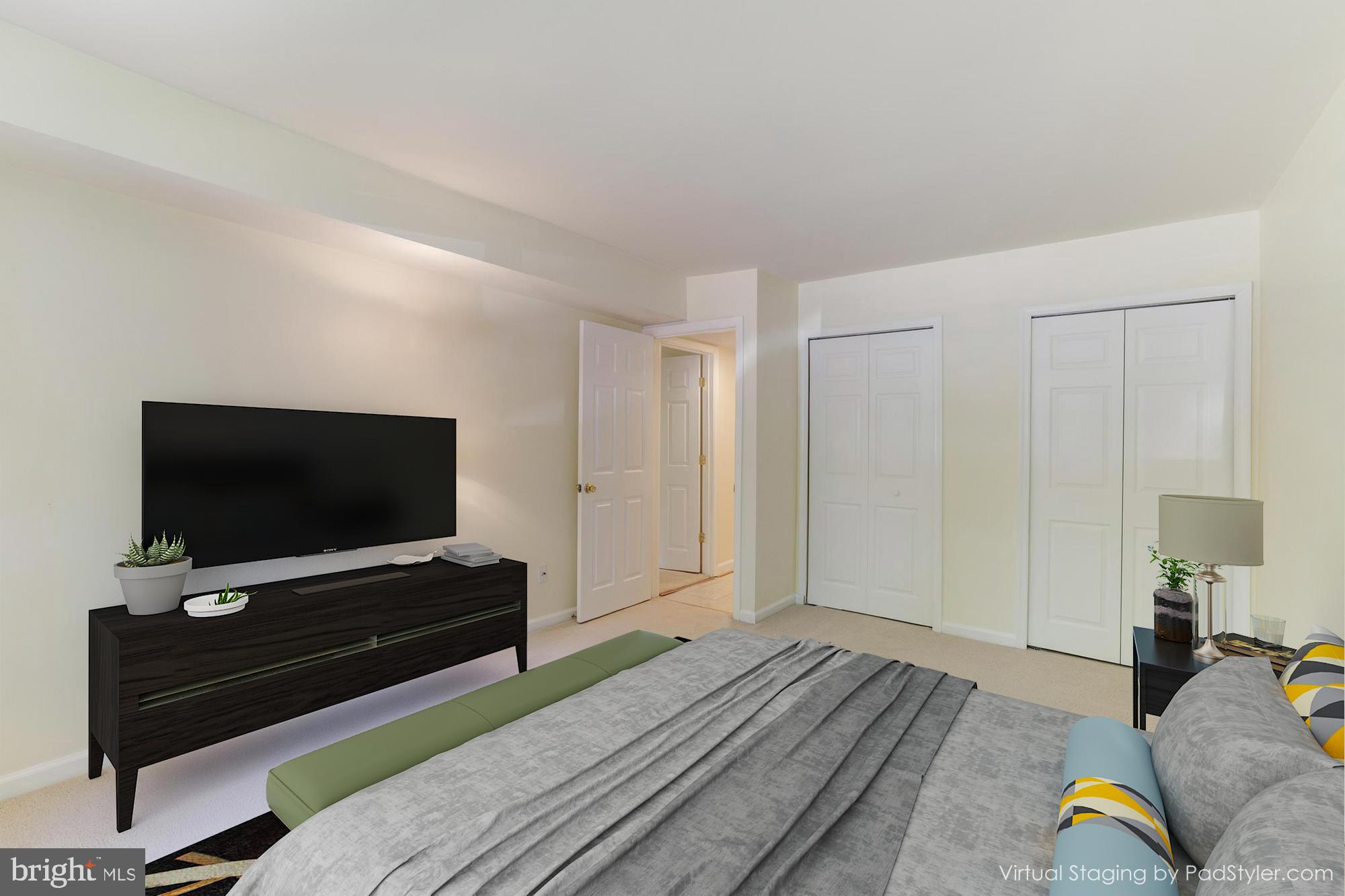 1631 Parkcrest Circle, Unit 8B/101 Reston, VA 20190 - Photo 17 of 27 Primary bedroom with a wall of closets