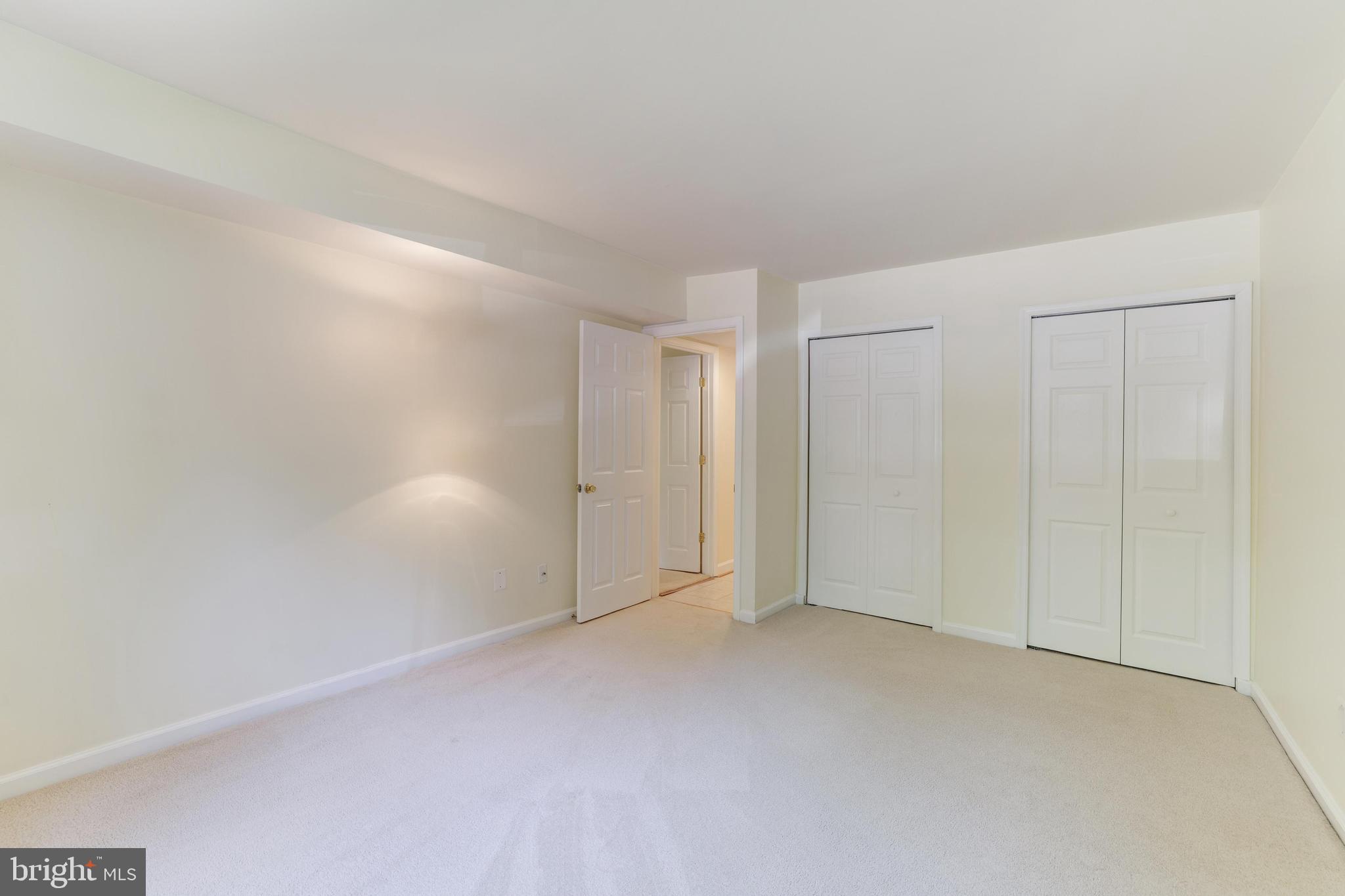 1631 Parkcrest Circle, Unit 8B/101 Reston, VA 20190 - Photo 18 of 27 Primary bedroom with a wall of closets