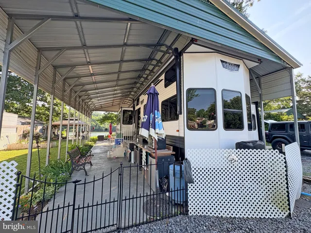 a view of a patio with table and chairs potted plants with wooden floor