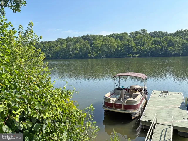 a view of a lake with a table and chairs