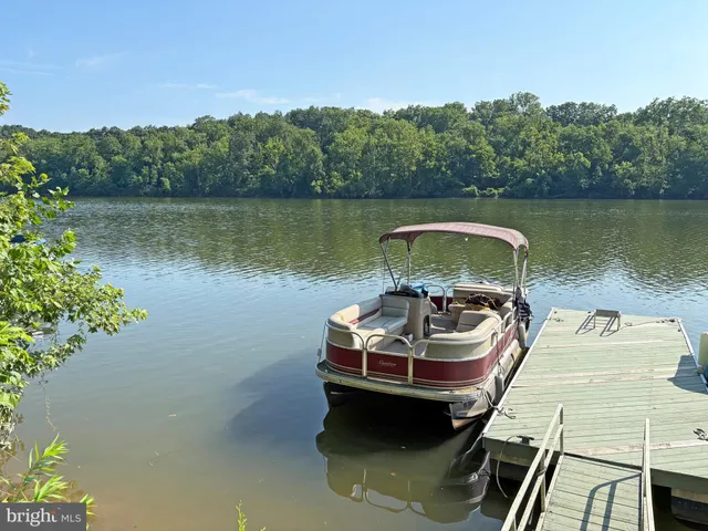 a view of a lake with a car parked on the side of a lake