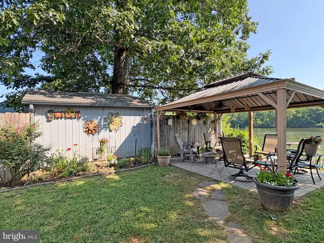 a view of a patio with table and chairs under an umbrella