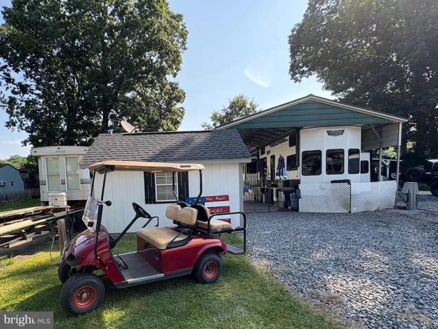 a view of a house with a yard and sitting area