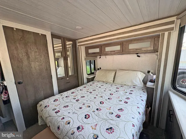 a bedroom with a bed and a mirror