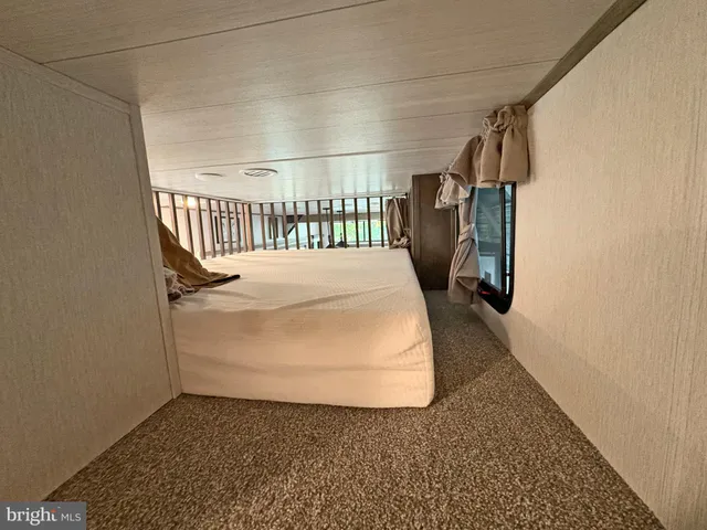 a bedroom with double bed and a chandelier