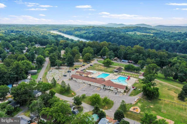 a view of yard with swimming pool and green space