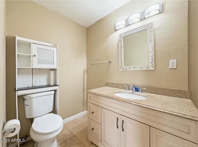 a bathroom with a toilet a sink and mirror