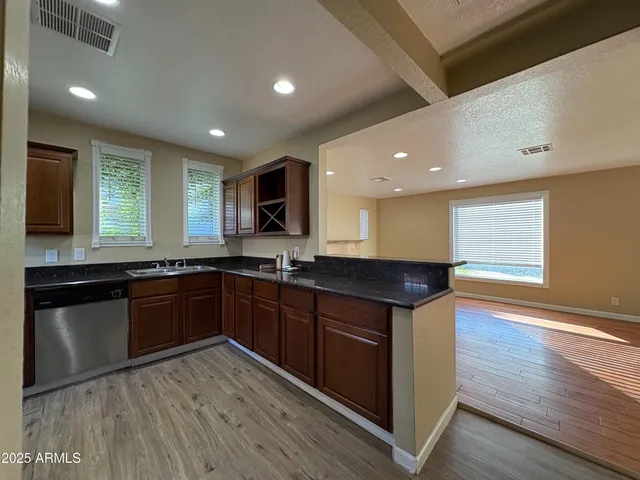 a kitchen with wooden cabinets and a sink