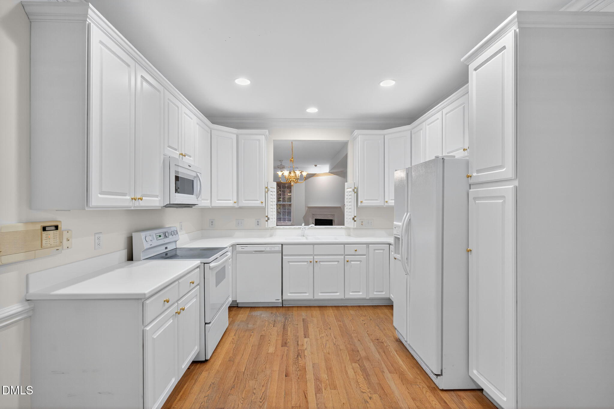 3421 Barron Berkeley Way Raleigh, NC 27612 - Photo 12 of 48 a kitchen with a sink cabinets stainless steel appliances and view living room