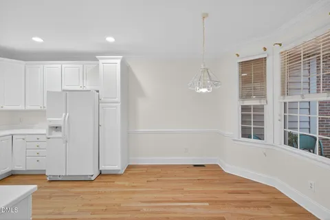 a kitchen with a sink cabinets stainless steel appliances and view living room