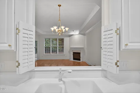 a kitchen with white cabinets white appliances and sink