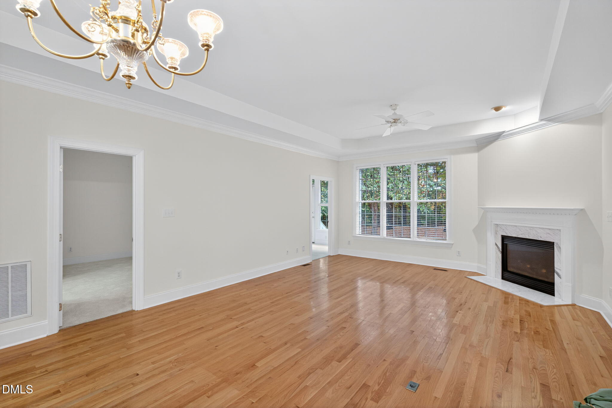 3421 Barron Berkeley Way Raleigh, NC 27612 - Photo 16 of 48 wooden floor fireplace and windows in an empty room