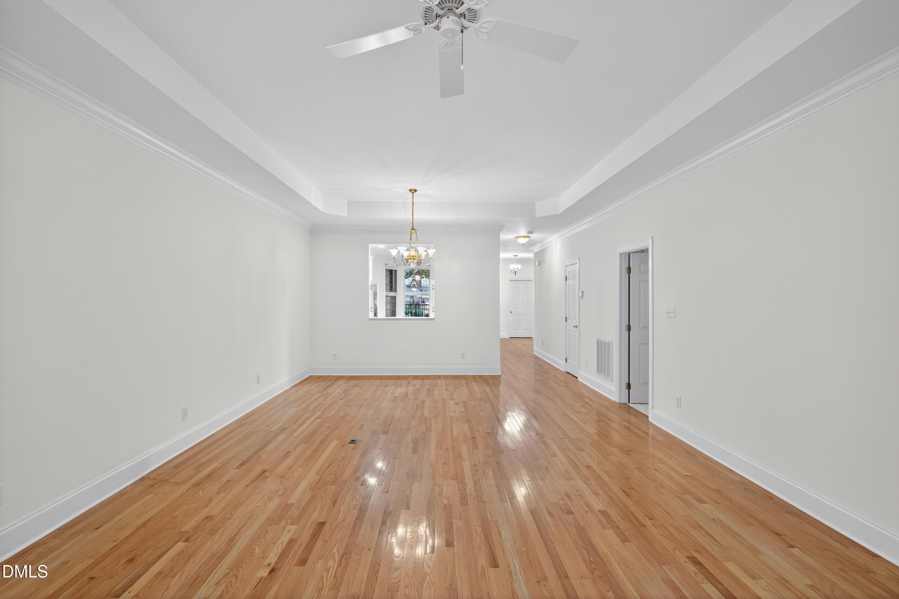 3421 Barron Berkeley Way Raleigh, NC 27612 - Photo 19 of 48 a view of an empty room with wooden floor and a window