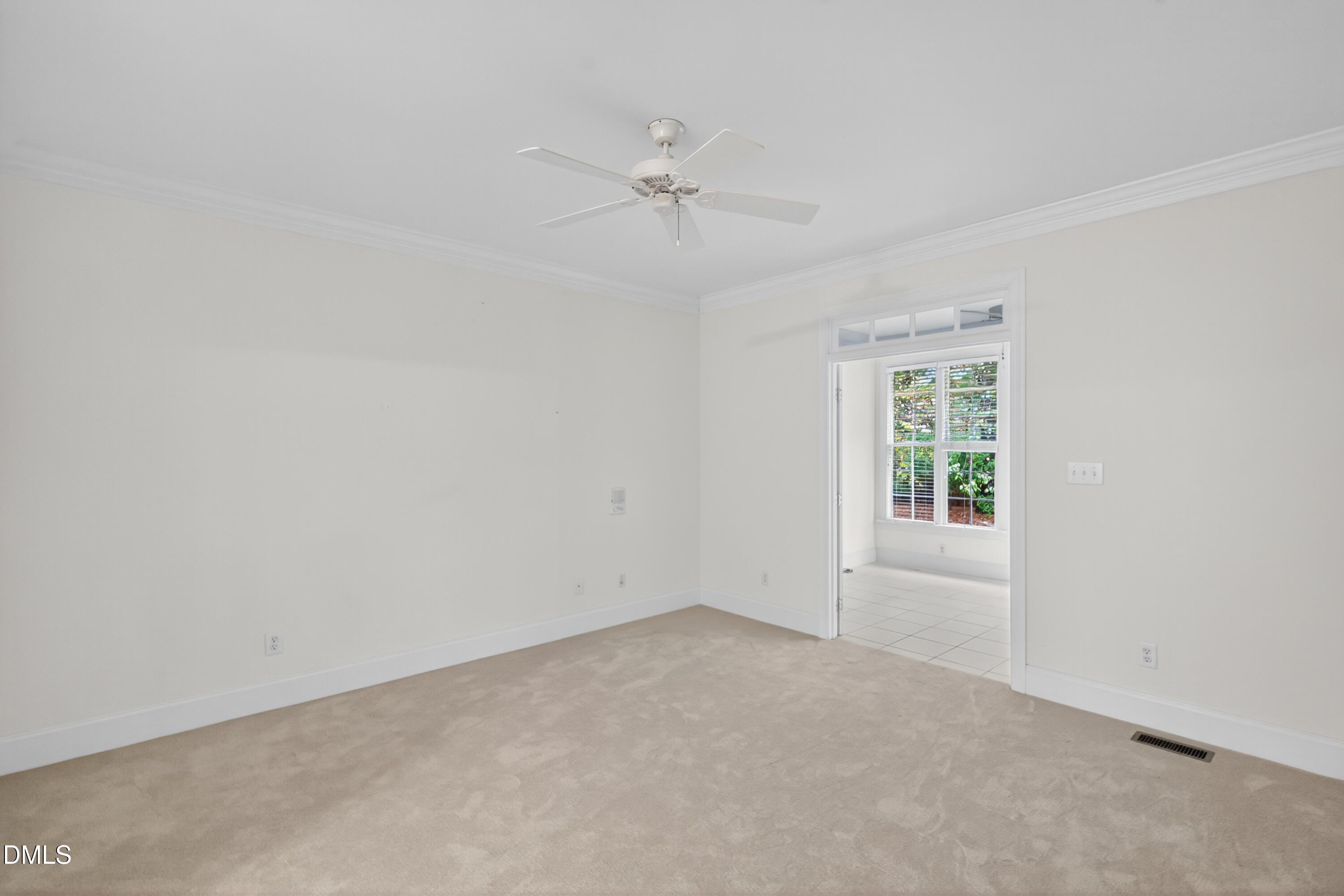 3421 Barron Berkeley Way Raleigh, NC 27612 - Photo 24 of 48 an empty room with a ceiling fan and a window
