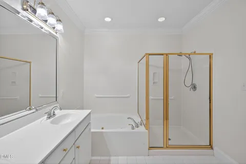 a bathroom with a tub sink and mirror