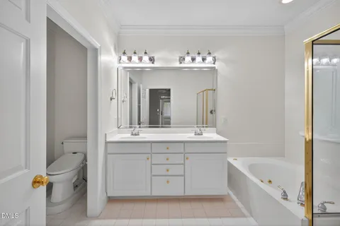 a spacious bathroom with a tub sink and mirror