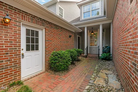 a view of a brick house with plants