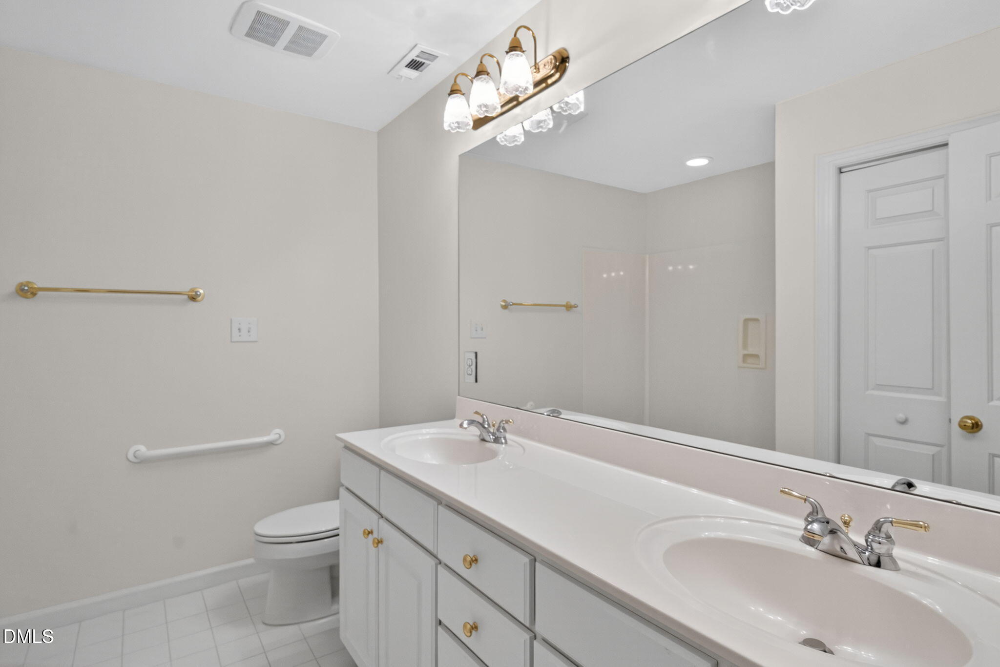 3421 Barron Berkeley Way Raleigh, NC 27612 - Photo 34 of 48 a bathroom with a toilet a sink and mirror