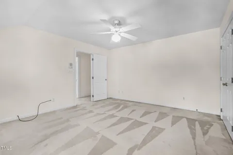 a view of an empty room with a ceiling fan
