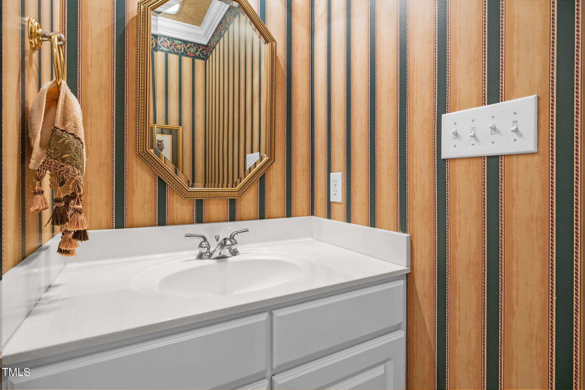 3421 Barron Berkeley Way Raleigh, NC 27612 - Photo 39 of 48 a bathroom with a sink and a mirror