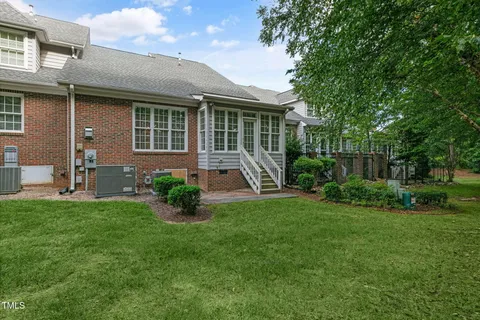 a front view of a house with a yard and outdoor seating