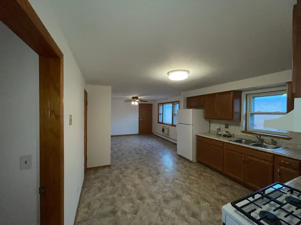 a kitchen with stainless steel appliances a sink stove and cabinets