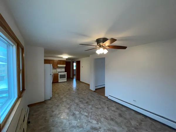 a view of a livingroom with a ceiling fan and window