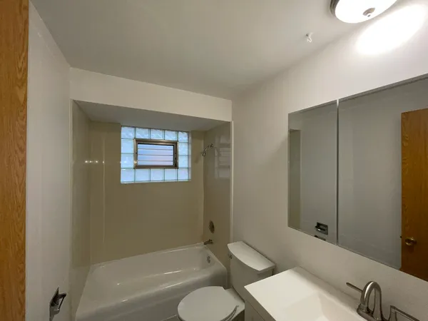 a bathroom with a toilet a sink and bathtub