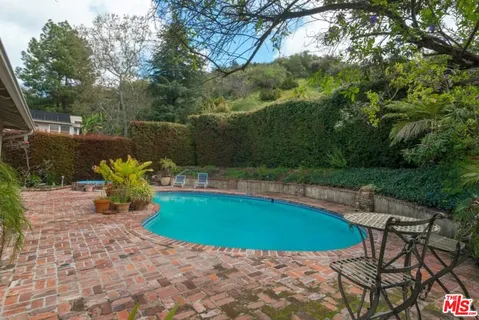 a view of a swimming pool with a patio