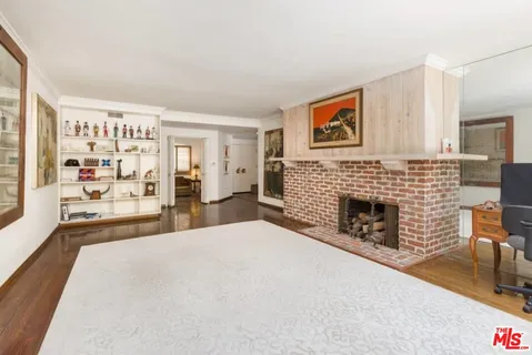 a spacious bedroom with a bed and a fireplace