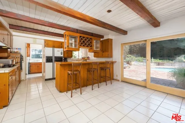 a kitchen with stainless steel appliances granite countertop a stove and a refrigerator