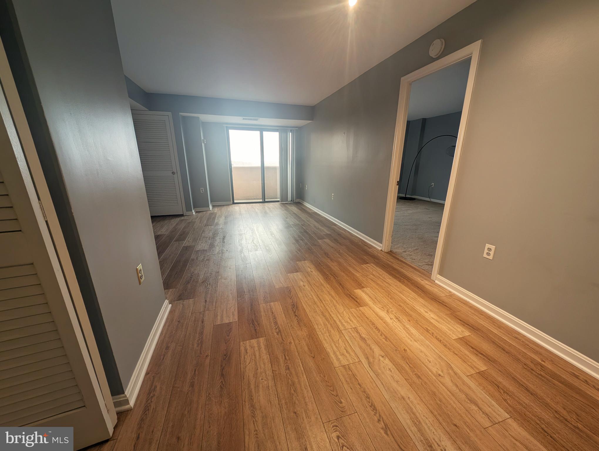 1301 North Courthouse Road, Unit 1202 Arlington, VA 22201 - Photo 2 of 17 wooden floor in an empty room with a window