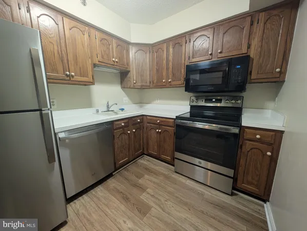 a kitchen with a sink stove and microwave