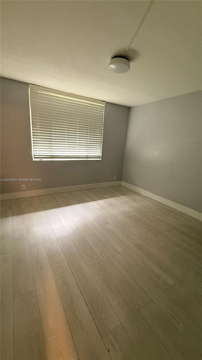 821 Lyons Road, Unit 21102 Coconut Creek, FL 33063 - Photo 7 of 17 an empty room with windows and entrance