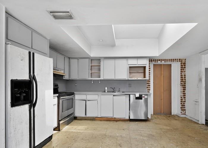 22164 Southwest 65th Terrace Boca Raton, FL 33428 - Photo 11 of 20 a kitchen with stainless steel appliances a refrigerator a sink a stove top oven a counter space and cabinets