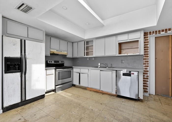 22164 Southwest 65th Terrace Boca Raton, FL 33428 - Photo 12 of 20 a kitchen with white cabinets and white appliances