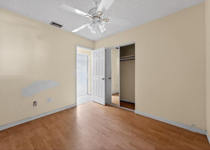 22164 Southwest 65th Terrace Boca Raton, FL 33428 - Photo 13 of 20 an empty room with wooden floor and ceiling fan