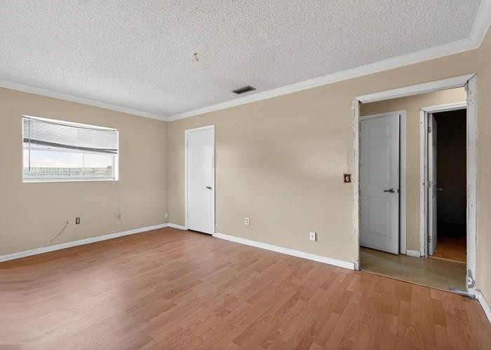 22164 Southwest 65th Terrace Boca Raton, FL 33428 - Photo 14 of 20 a view of an empty room with wooden floor and a window