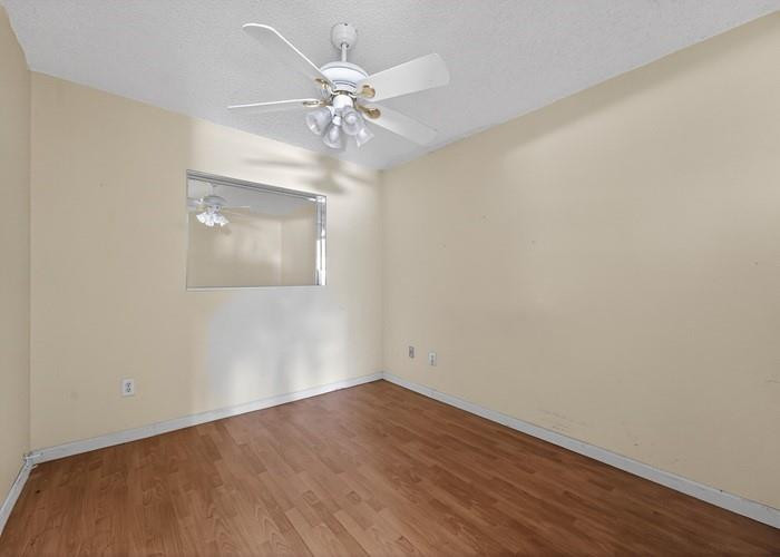 22164 Southwest 65th Terrace Boca Raton, FL 33428 - Photo 16 of 20 a view of an empty room with wooden floor