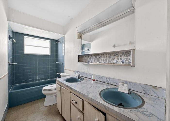 22164 Southwest 65th Terrace Boca Raton, FL 33428 - Photo 20 of 20 a bathroom with a granite countertop sink a toilet a mirror and shower