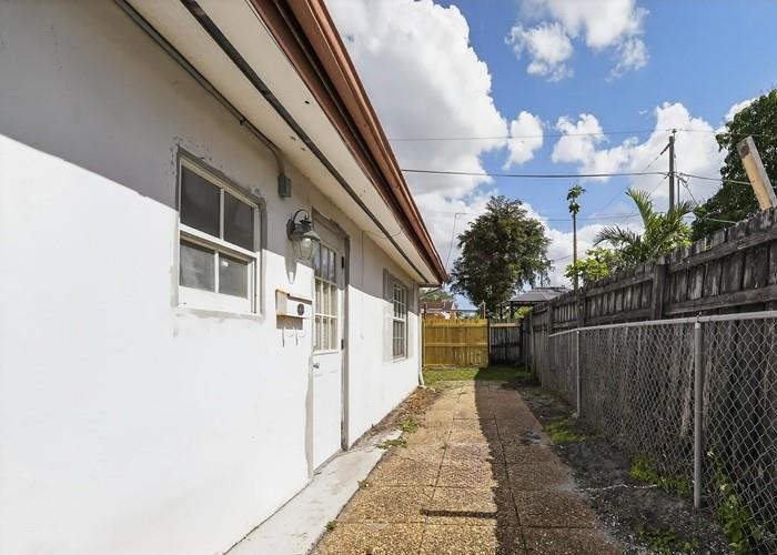 22164 Southwest 65th Terrace Boca Raton, FL 33428 - Photo 5 of 20 a view of a pathway of a house with wooden fence