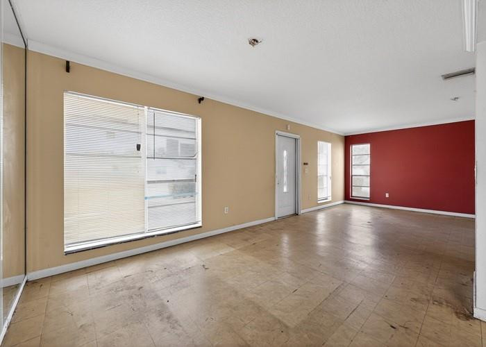 22164 Southwest 65th Terrace Boca Raton, FL 33428 - Photo 7 of 20 an empty room with cabinet and windows