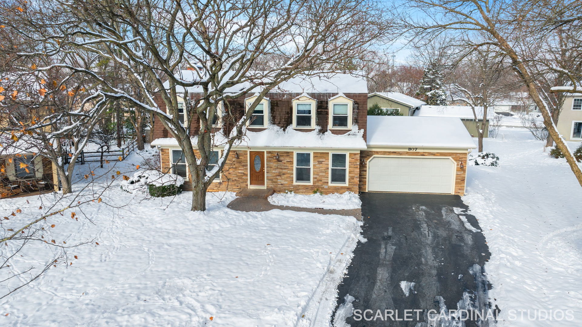 307 Leeds Court Naperville, IL 60565 - Photo 24 of 27 a front view of a house with a yard covered in snow