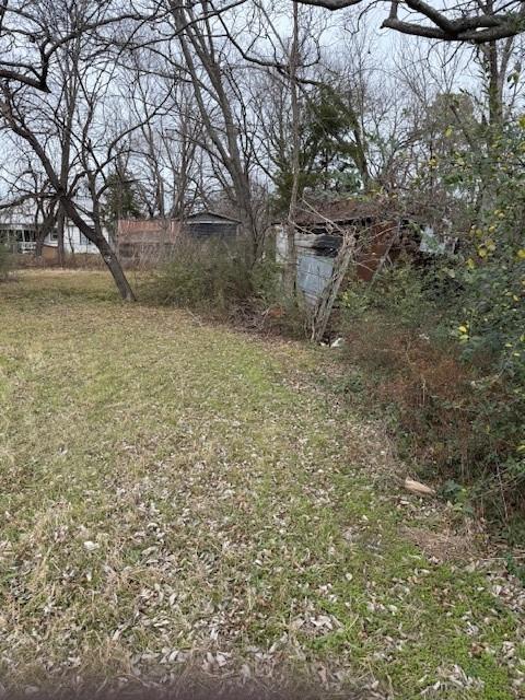 818 West 9th Street Bonham, TX 75418 - Photo 7 of 8 a view of a yard with a tree