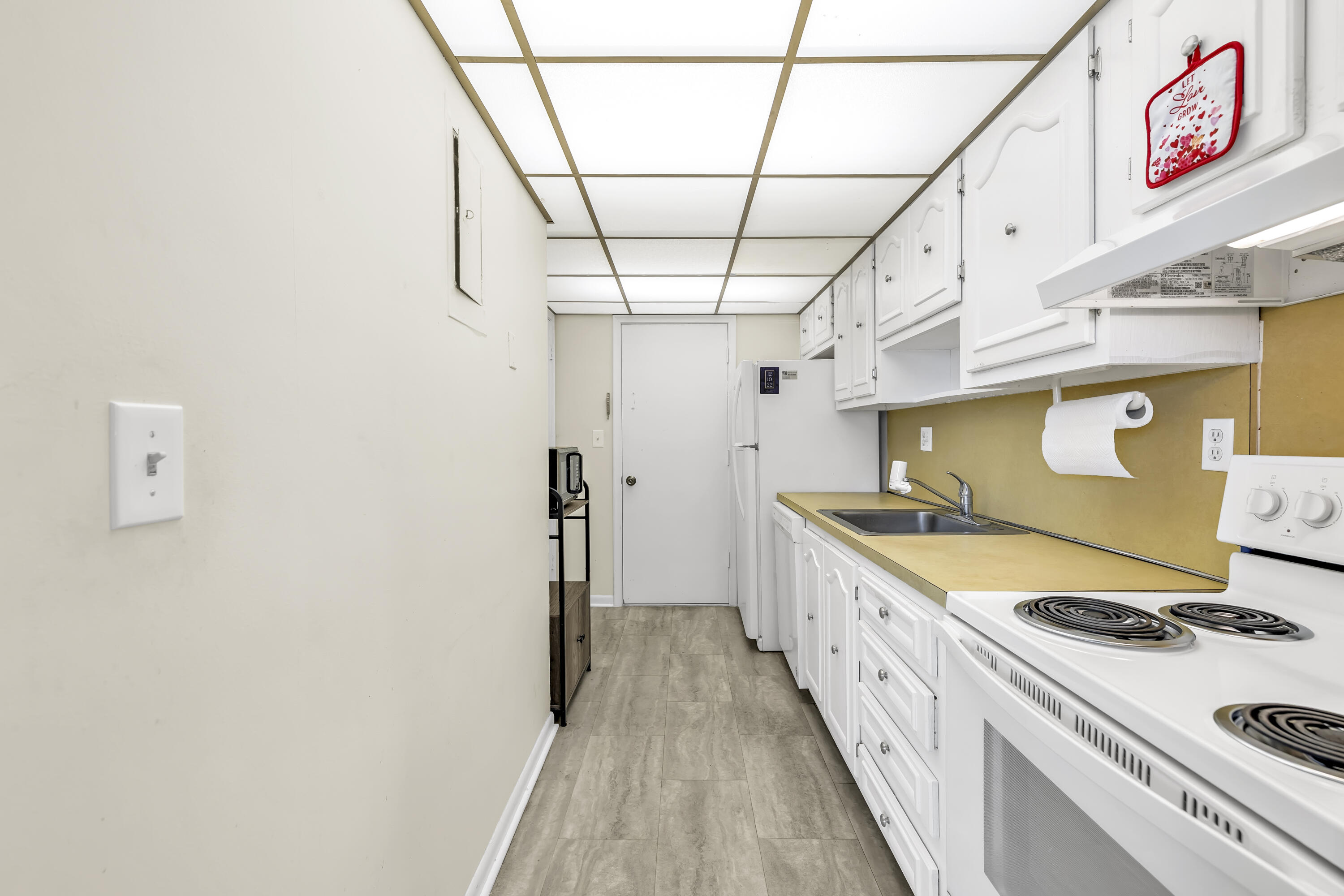 298 Southwest 6th Street, Unit 204 Boca Raton, FL 33432 - Photo 13 of 22 a kitchen with a stove and a refrigerator