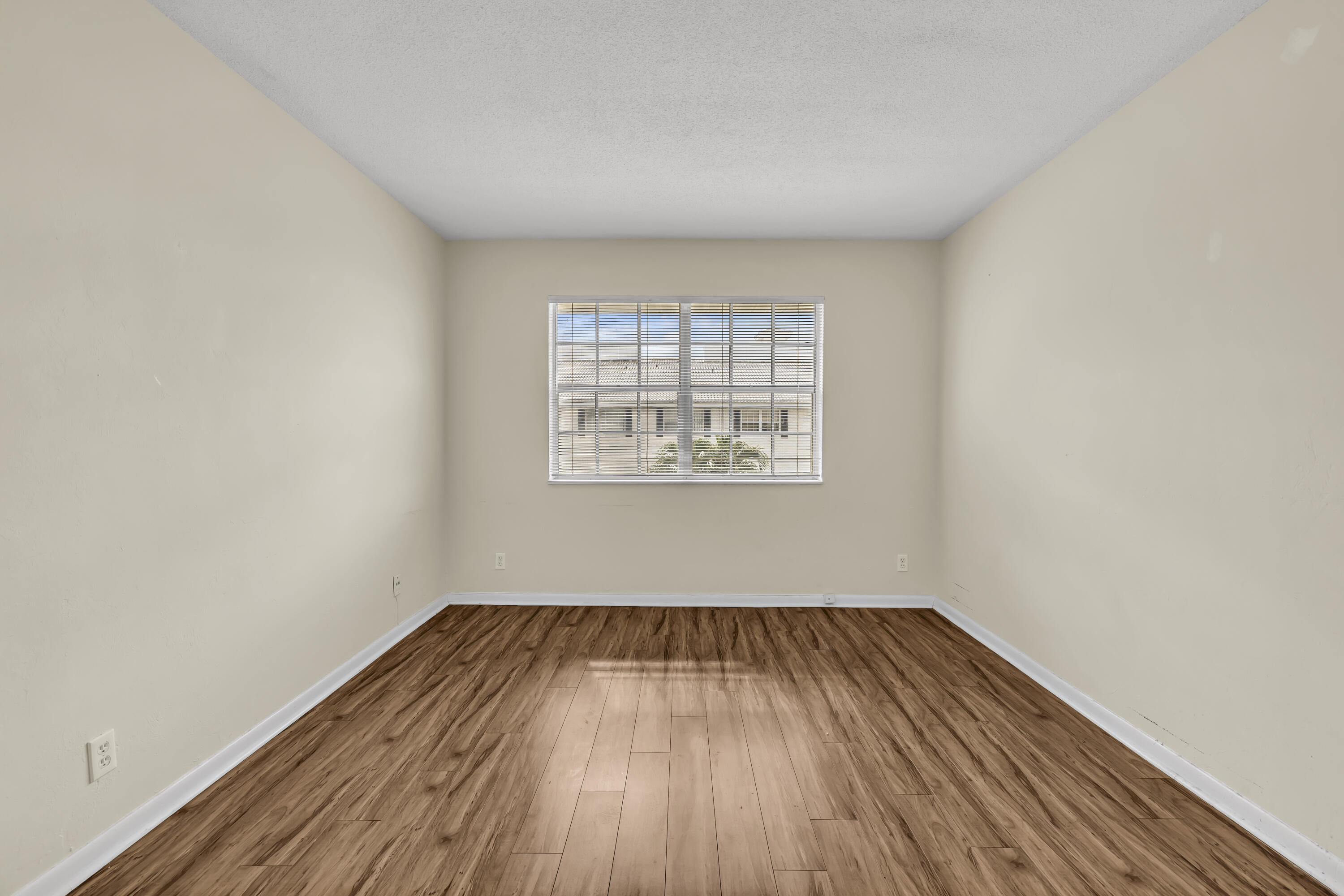 298 Southwest 6th Street, Unit 204 Boca Raton, FL 33432 - Photo 14 of 22 an empty room with wooden floor and windows