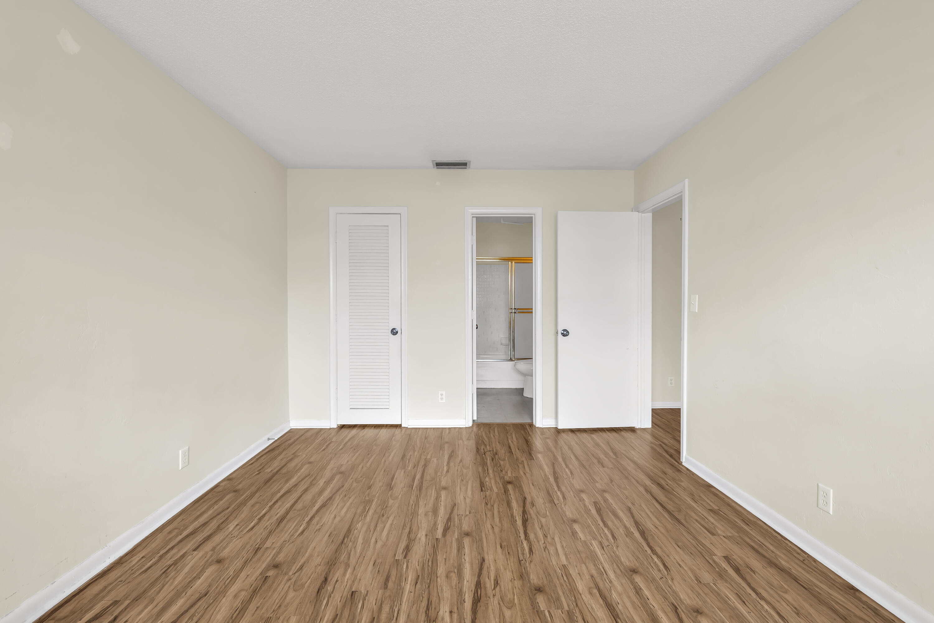 298 Southwest 6th Street, Unit 204 Boca Raton, FL 33432 - Photo 16 of 22 a view of a room with wooden floor and white walls