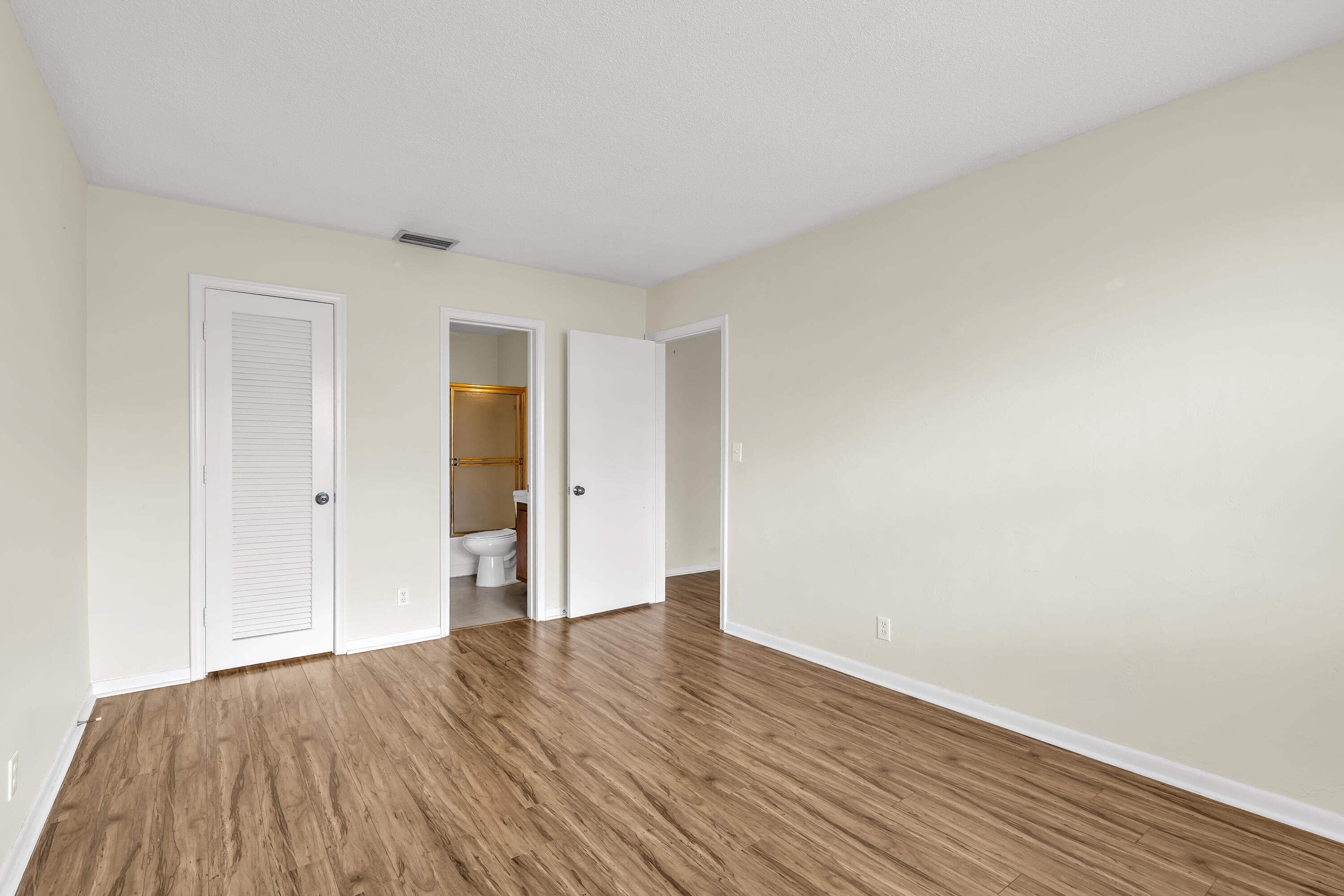 298 Southwest 6th Street, Unit 204 Boca Raton, FL 33432 - Photo 17 of 22 a view of an empty room with wooden floor