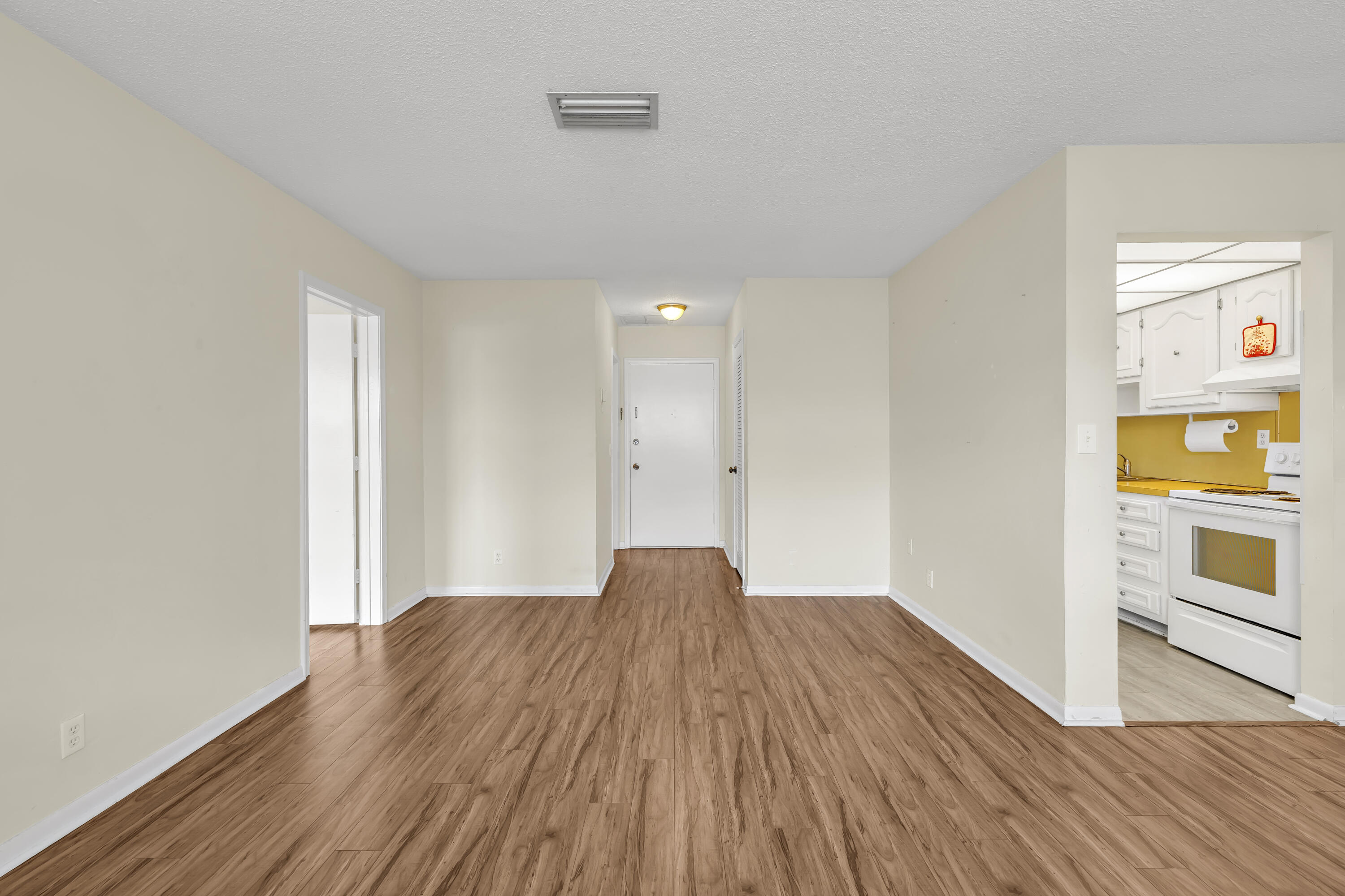 298 Southwest 6th Street, Unit 204 Boca Raton, FL 33432 - Photo 9 of 22 a view of empty room with wooden floor